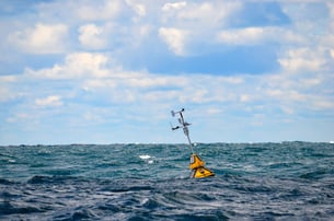 Weather buoy drifting on sea