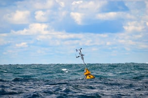 Weather buoy drifting on sea